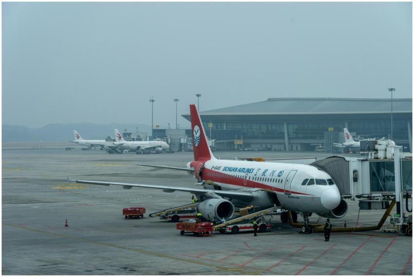 Sichuan Airlines Airbus A320 parked at a busy airp