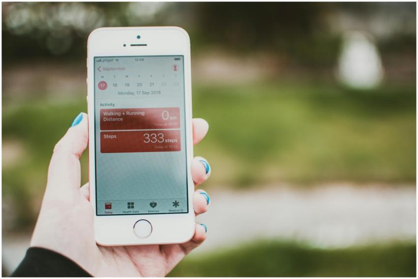 A person holds a smartphone showing a fitness app