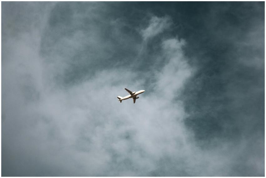 A commercial airplane soaring through vast clouds