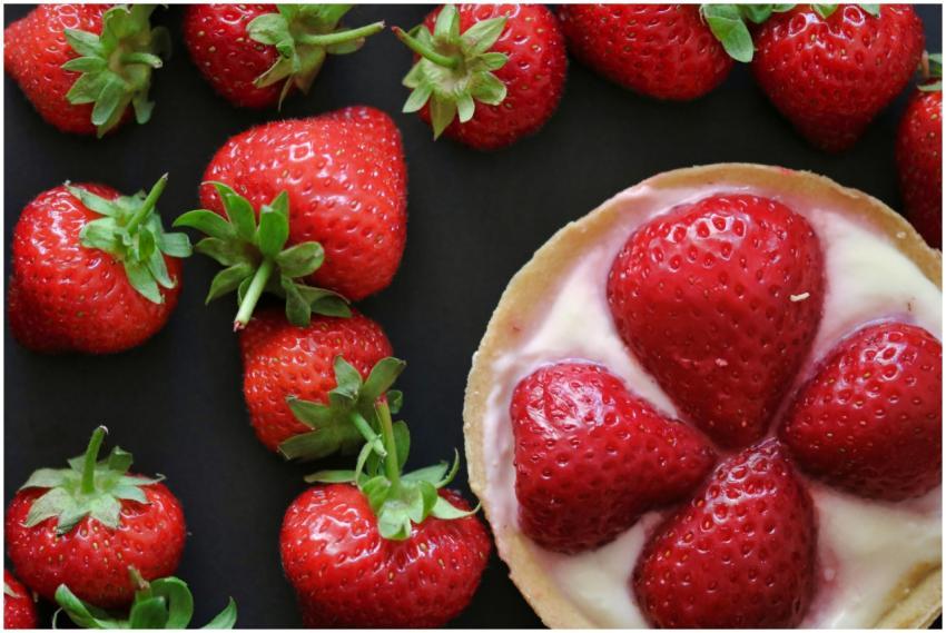 Top view of fresh strawberries and a delicious cre