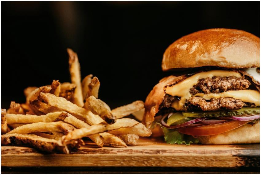 Mouthwatering cheeseburger and crispy fries on a w