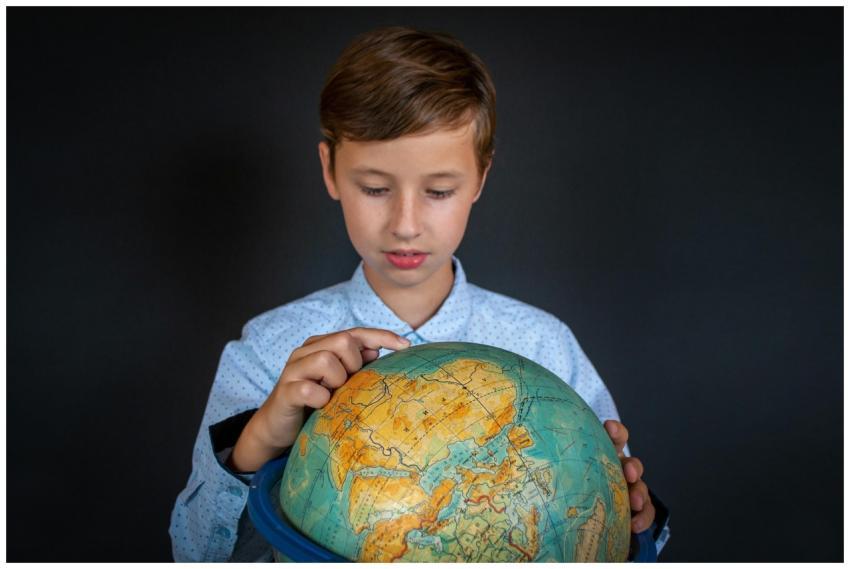 A child engaged in learning geography by studying