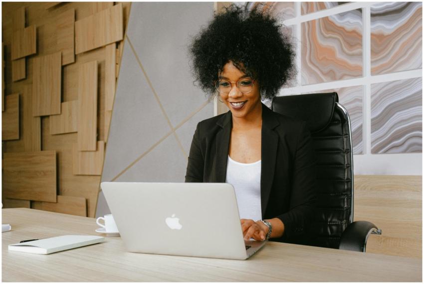 Smiling woman working remotely on a laptop in a st