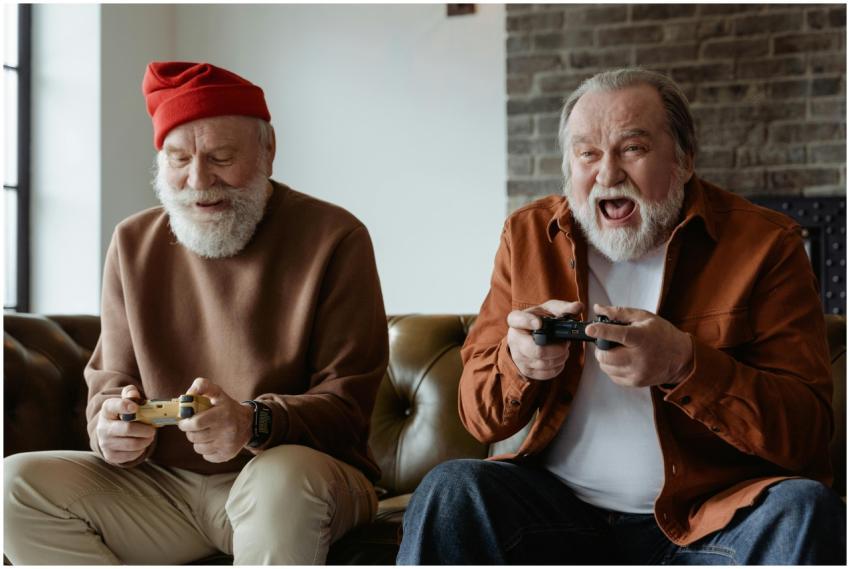 Two senior men laughing and playing video games, s