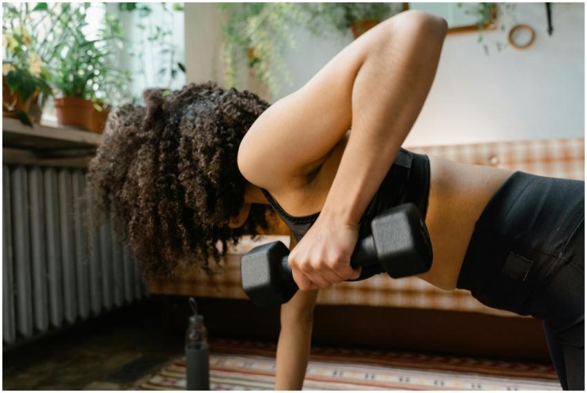 African American woman working out with dumbbells