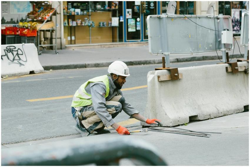 A construction worker operates on a city street in
