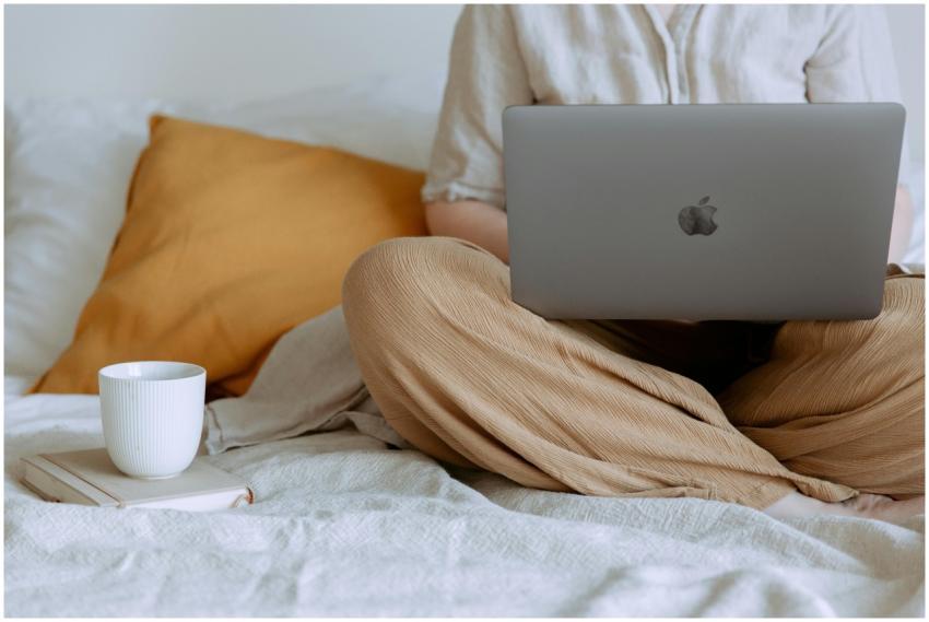 Crop faceless female in casual outfit sitting on b