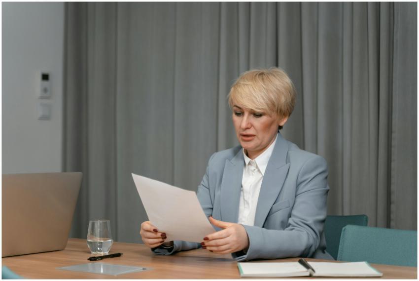 Businesswoman in a blazer reviewing documents at a