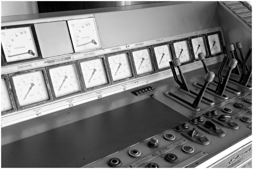 Black and white photo of a vintage control panel w