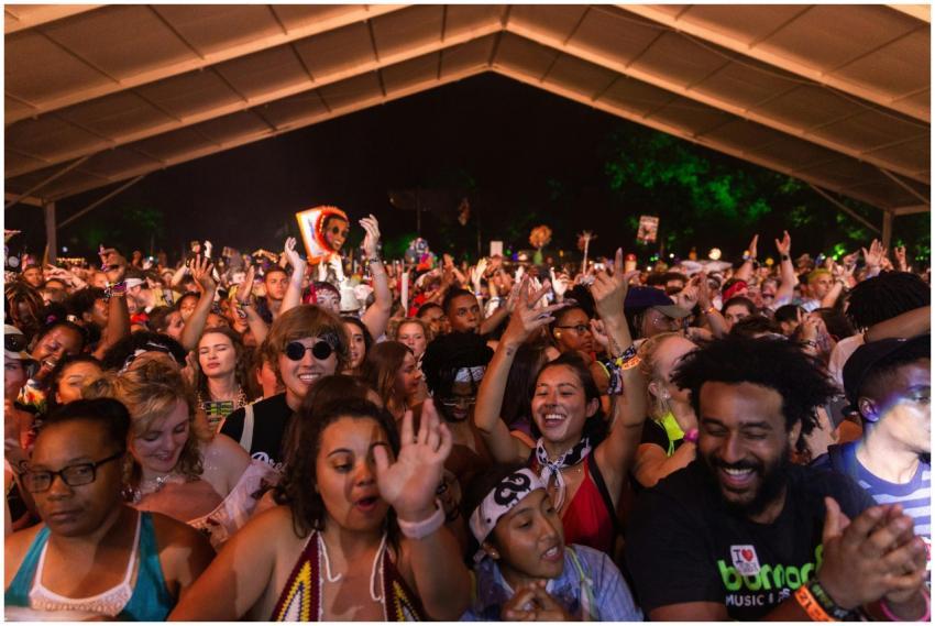 A lively night scene with a diverse crowd enjoying