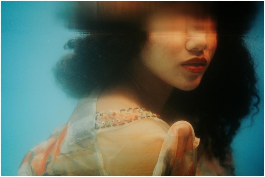 Artistic portrait of a woman with wavy hair agains