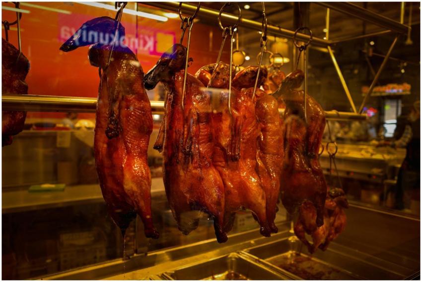 Succulent roasted ducks hanging on display in a Se