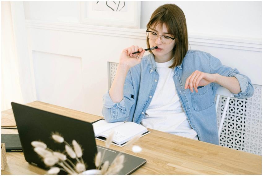 Woman working thoughtfully in home office, reflect