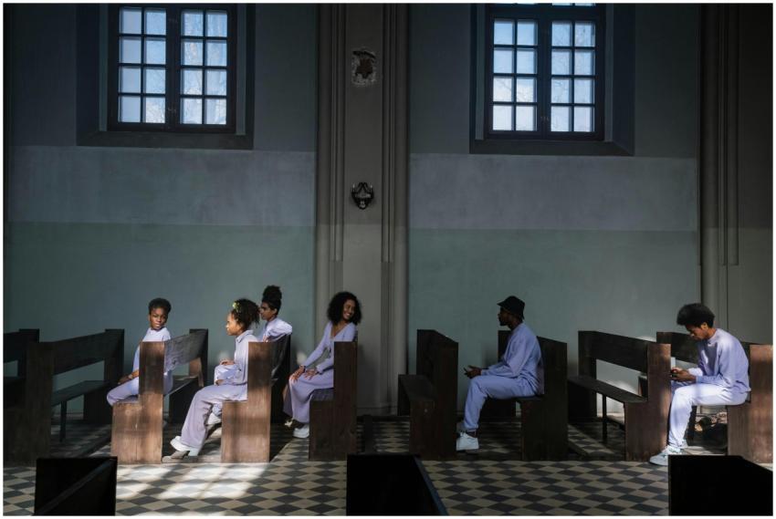 Group of choir members seated in church pews with