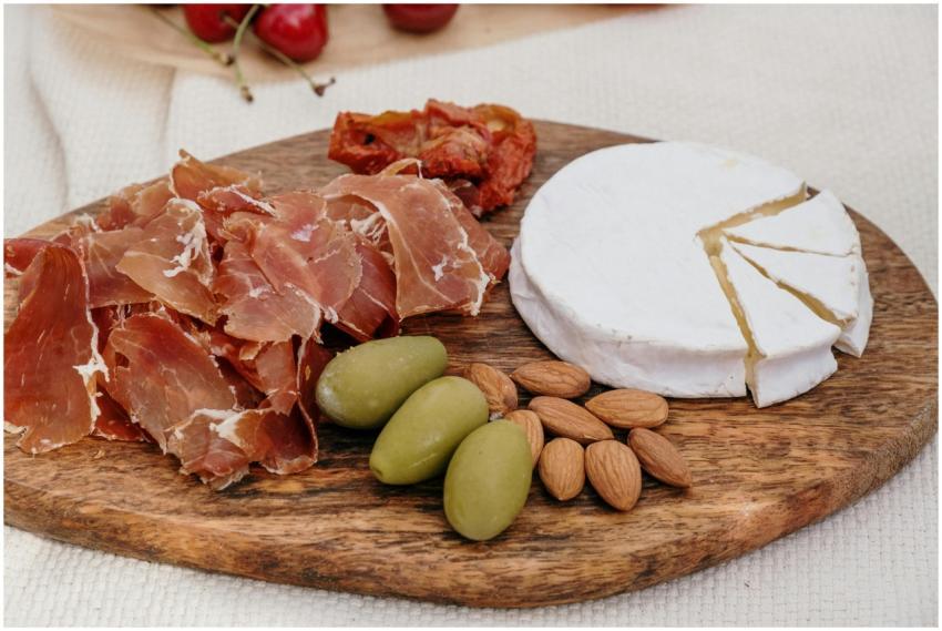 A delectable charcuterie board featuring brie chee