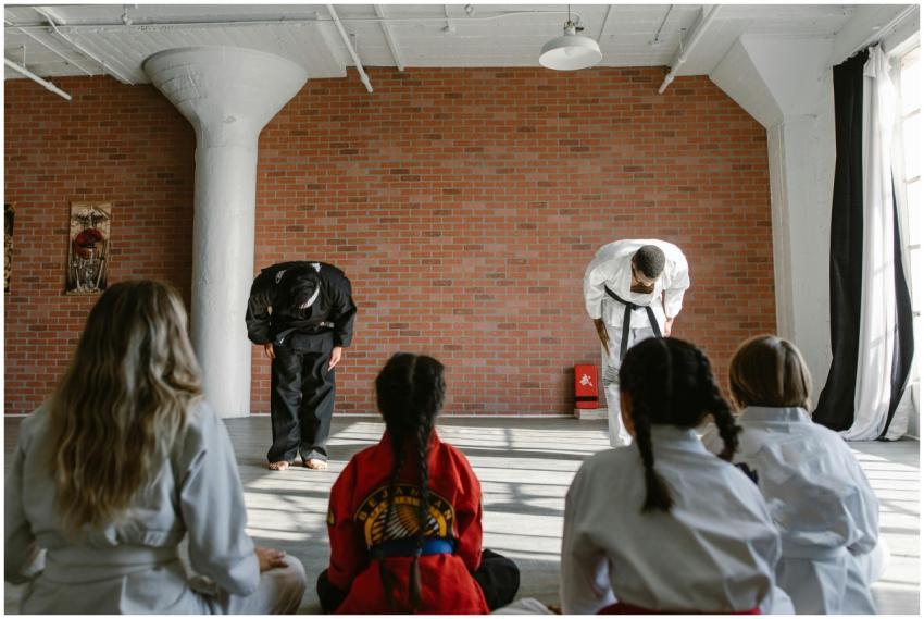 Martial arts teachers bowing to students in a dojo