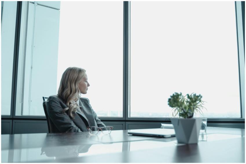 A businesswoman in a suit looking out the window o