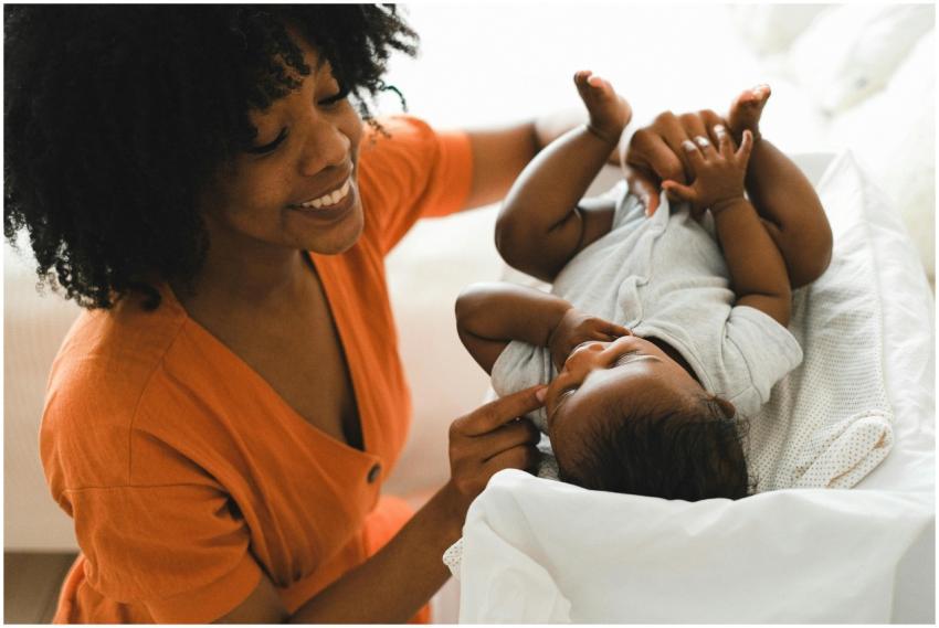 A loving mother playfully engages with her baby on