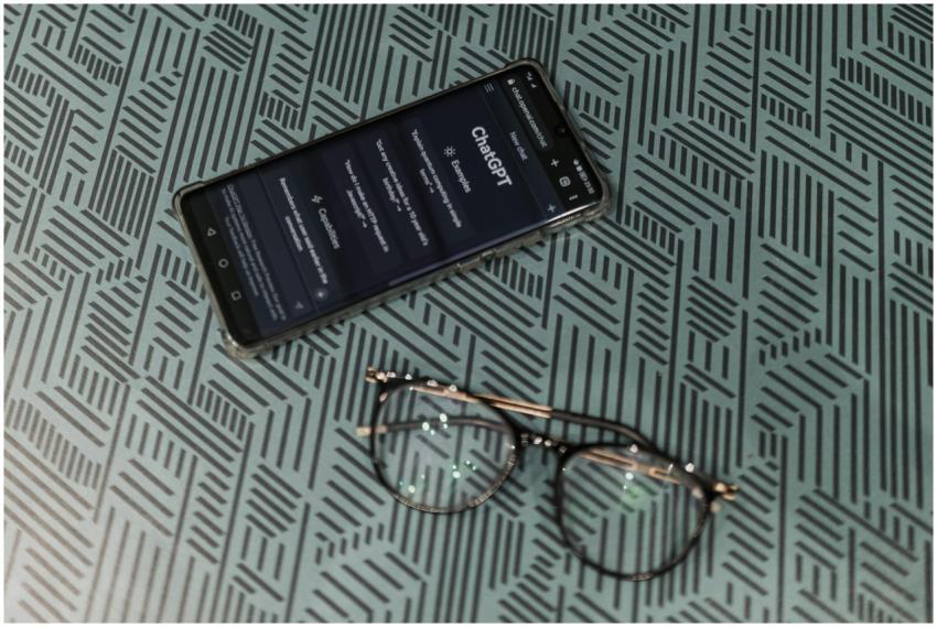 Close-up of smartphone displaying ChatGPT alongsid