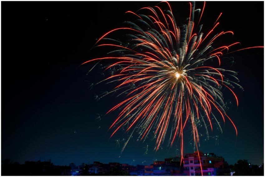 Colorful fireworks illuminating a dark night sky o