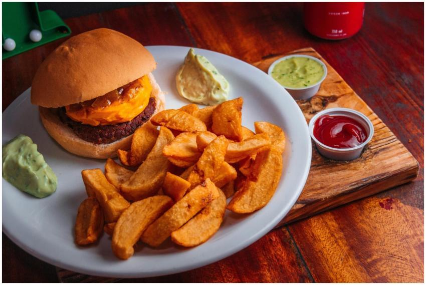 Tasty cheeseburger with crispy potato wedges and a