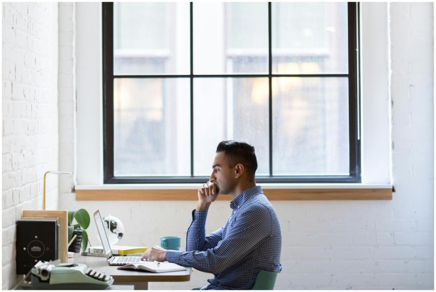 Focused male professional working on a laptop at a