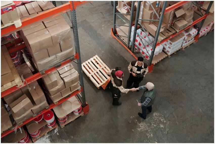 High angle view of workers shaking hands in a ware