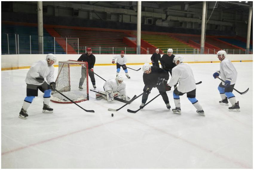 Team practicing ice hockey with intense action on