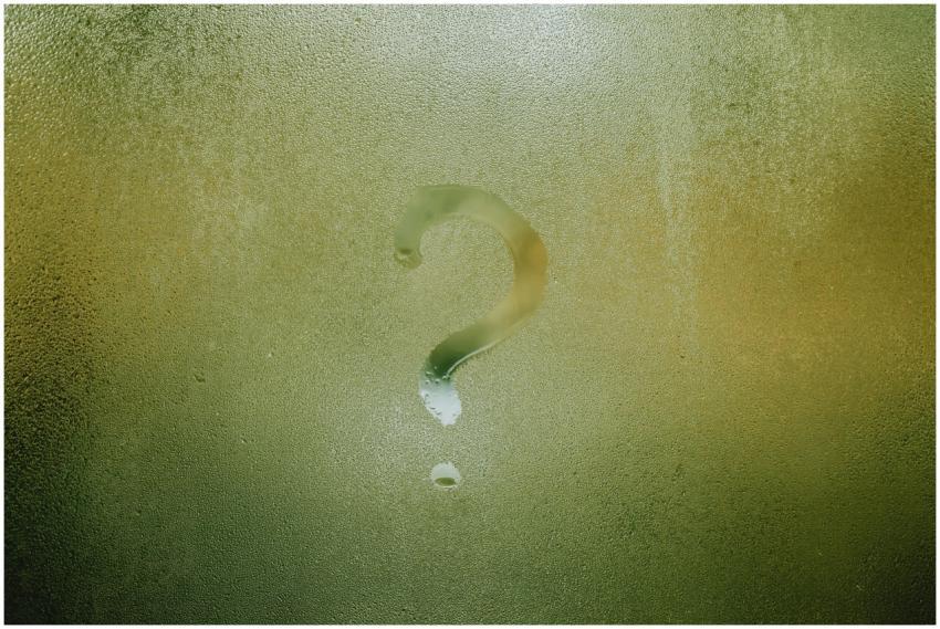 A question mark drawn on foggy glass, evoking curi