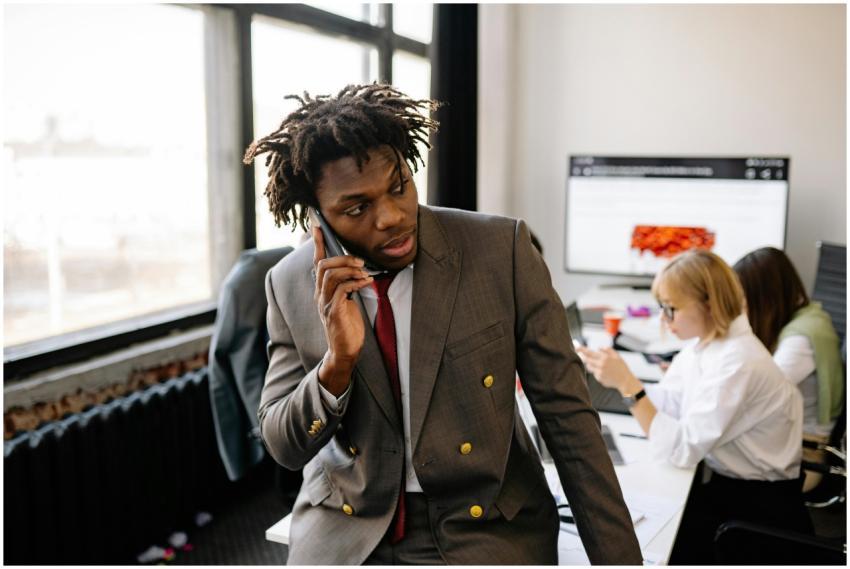 Businessman in a suit talking on the phone in a bu