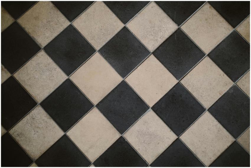 Diagonal black and white checkered floor tiles wit