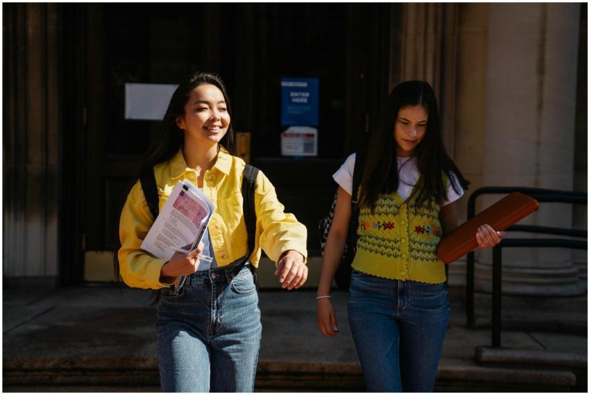 Two college students walking together, smiling and