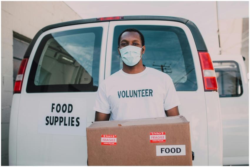 African American volunteer distributing food suppl