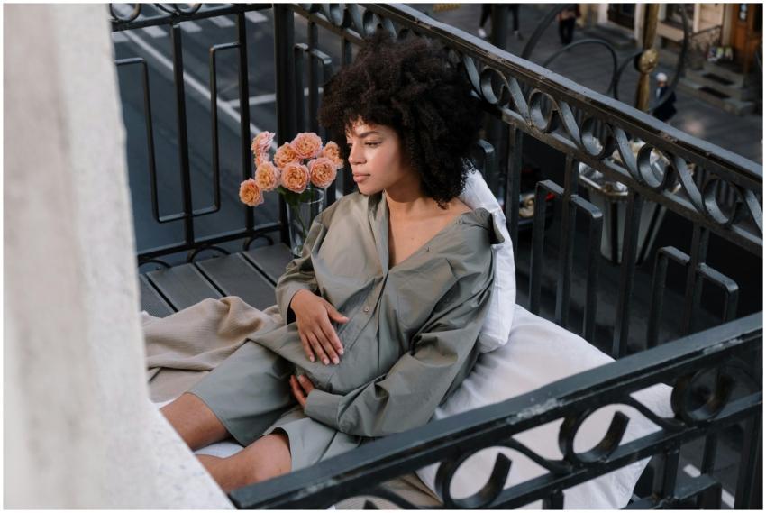 Serene portrait of a pregnant woman sitting on a c