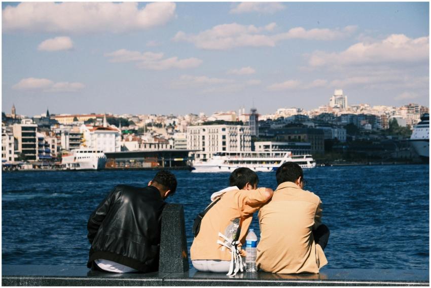 Three young adults enjoying a sunny day by the Bos