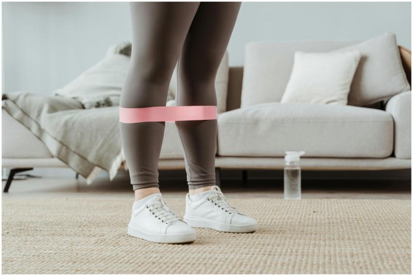 Close-up of a woman in sport leggings using a pink
