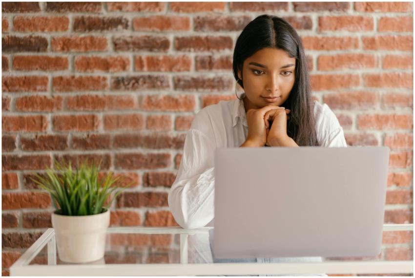 Young woman deeply focused on her laptop studying