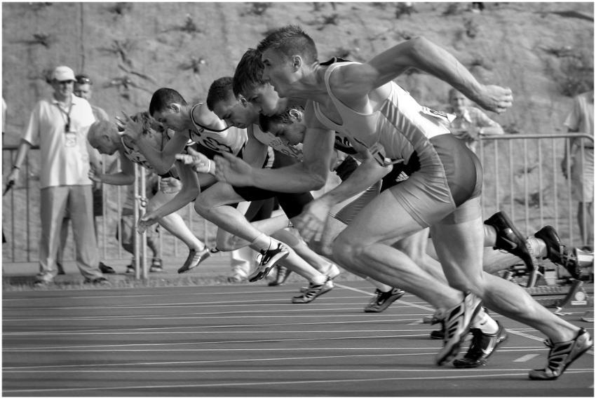 Athletes burst from the blocks during a sprint rac