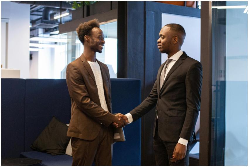 Two professional men shaking hands in a modern off