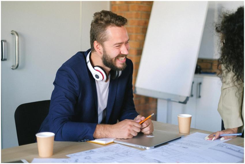 A cheerful man with headphones discussing a projec