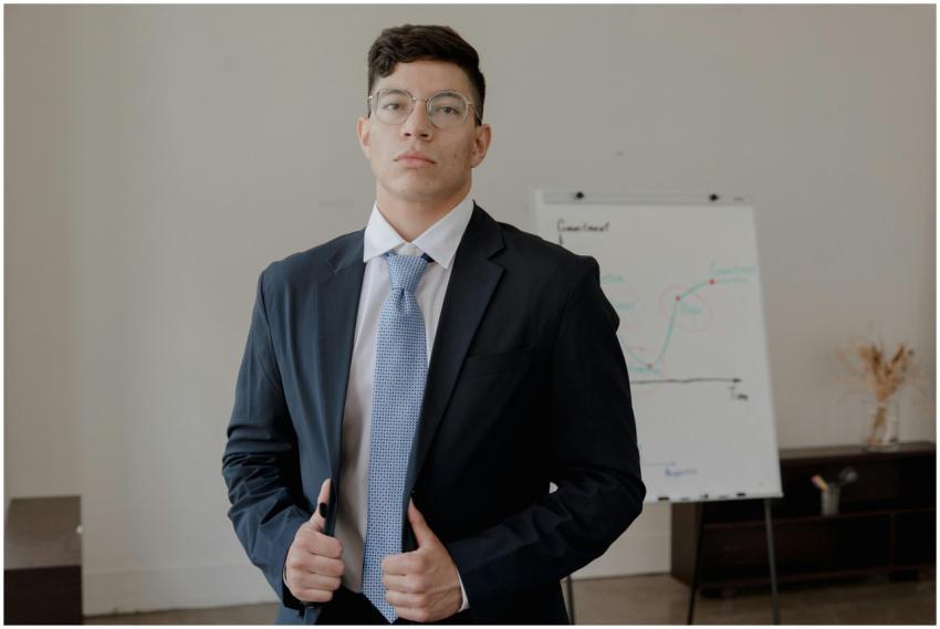 A well-dressed businessman in a suit stands confid
