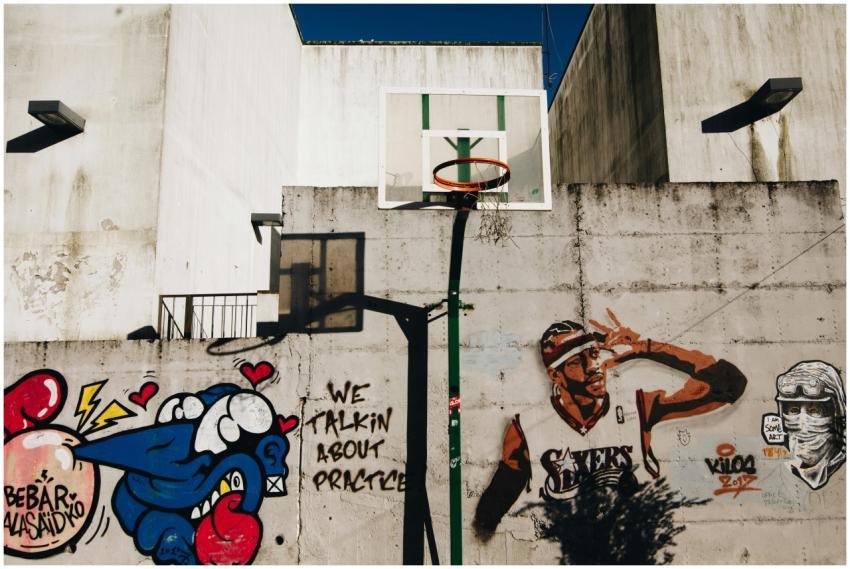 Urban basketball hoop with vibrant street art on a