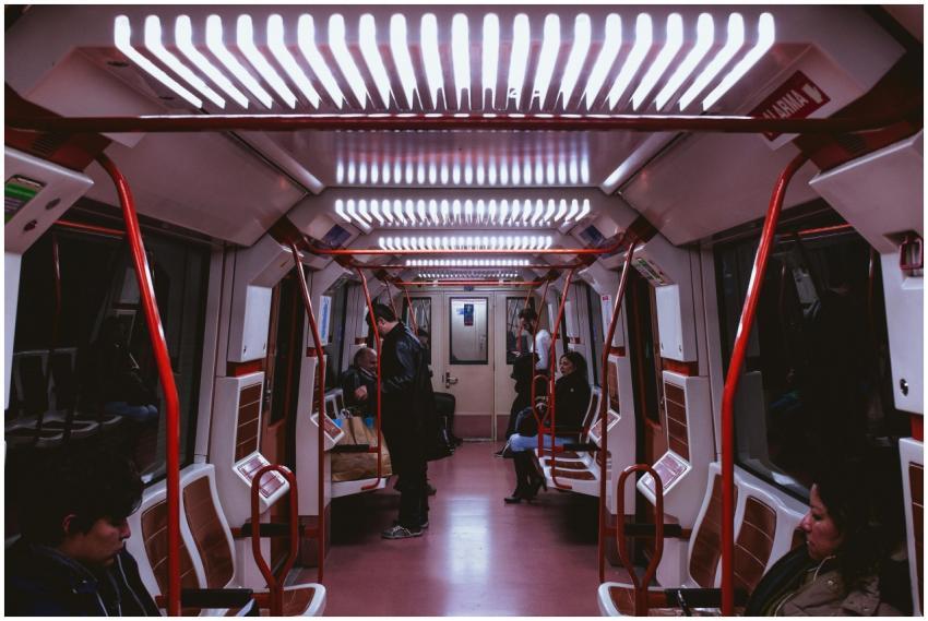 View of people inside a modern subway train at nig