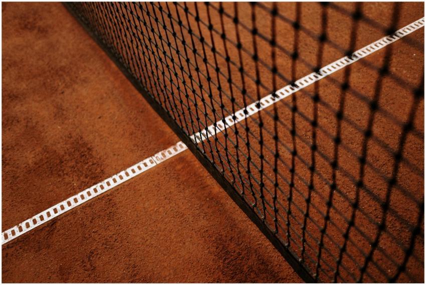Detailed close-up of a clay tennis court featuring