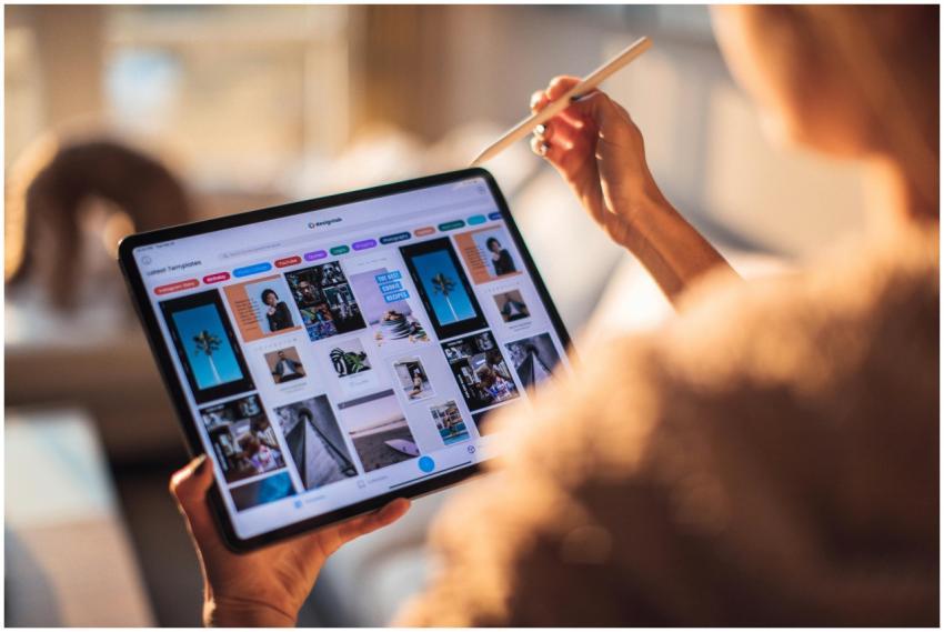 A person uses a digital tablet with a stylus indoo