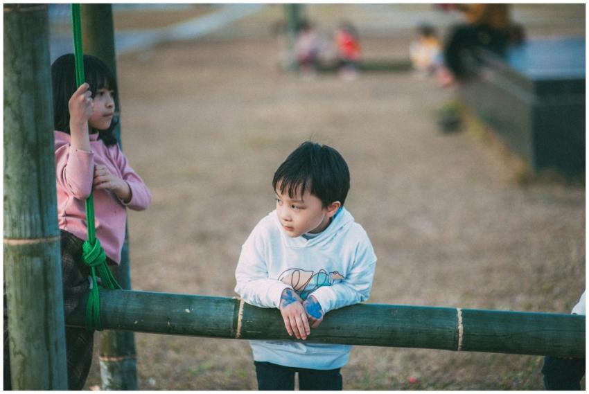 Young kids enjoying playtime outdoors on a wooden