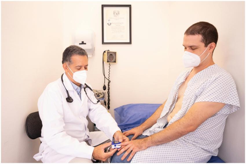 A doctor examines a patient with a pulse oximeter