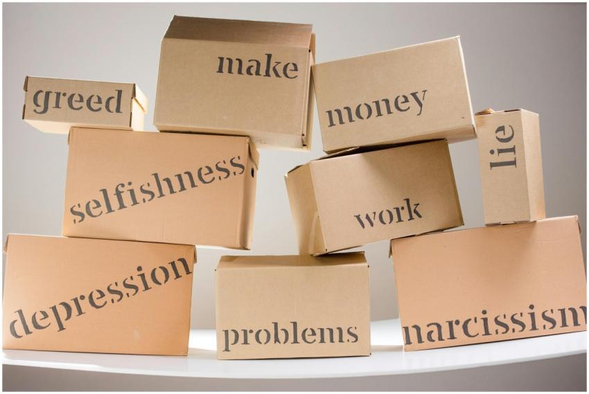 Stacked cardboard boxes displaying words like gree