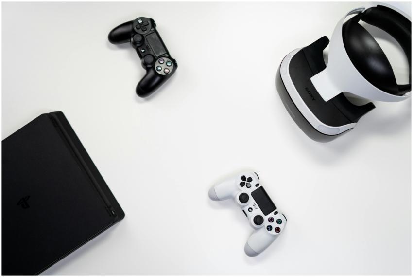 Flat lay of gaming console, controllers, and VR he