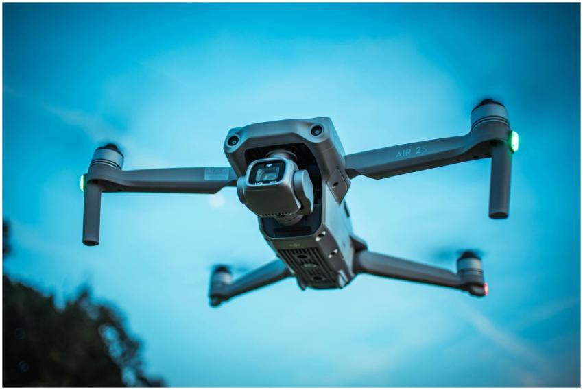 A modern drone soaring through a bright blue sky,